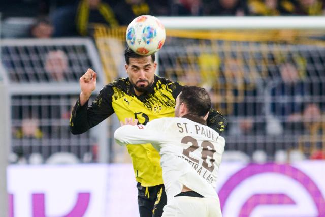17 January 2026, North Rhine-Westphalia, Dortmund: Borussia Dortmund's Emre Can (L) and St. Pauli's Mathias Pereira Lage in action during the German Bundesliga soccer match between Borussia Dortmund and FC St. Pauli at the Signal Iduna Park. Photo: Bernd Thissen/dpa - IMPORTANT NOTICE: DFL and DFB regulations prohibit any use of photographs as image sequences and/or quasi-video.