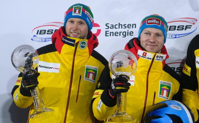 17 January 2026, Saxony, Altenberg: Germany's second placed Francesco Friedrich (R) and Alexander Schueller celebrate holding the crystal globes after the second run of men's two-man bobsleigh competition during the IBSF Bobsleigh World Cup in Altenberg. Photo: Robert Michael/dpa