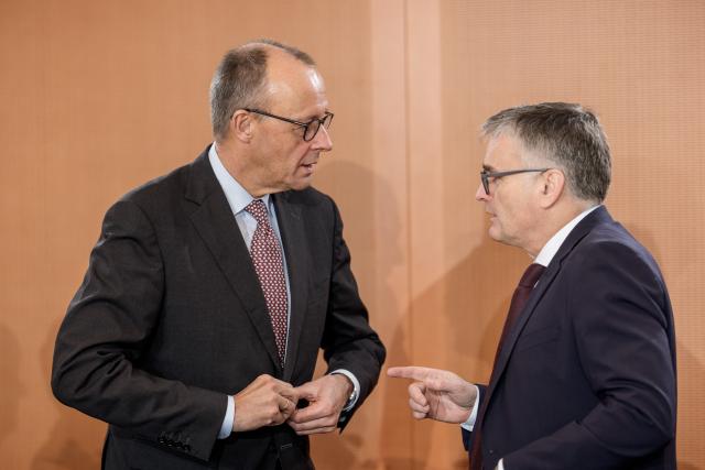 FILED - 03 December 2025, Berlin: German Chancellor Friedrich Merz (L) talks with Stefan Kornelius, government spokesman, before the start of the Cabinet meeting at the Chancellery. Photo: Michael Kappeler/dpa