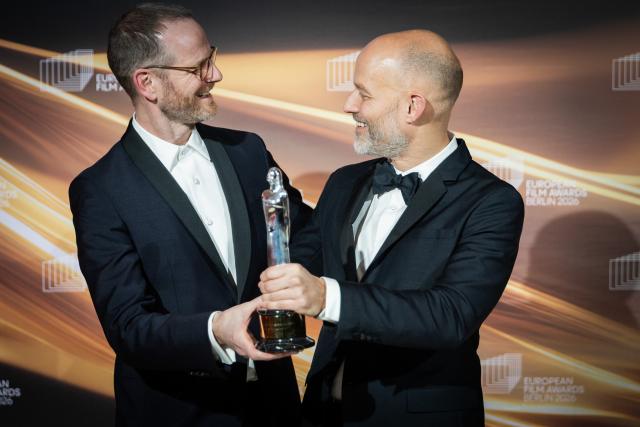 17 January 2026, Berlin: Norwegian film directors Eskil Vogt and Joachim Trier are honored in the "European Screenwriter" category at the 38th European Film Awards at the Haus der Kulturen der Welt. Photo: Christoph Soeder/dpa