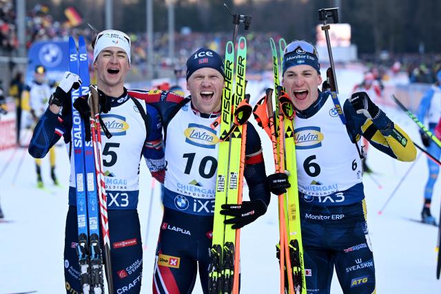 18 January 2026, Bavaria, Ruhpolding: (L-R) France's runner-up Eric Perrot, Norway's winner Johannes Dale-Skjevdal and Sweden's third placed Martin Ponsiluoma celebrate after the Men's 12.5 km pursuit competition of the IBU Biathlon World Cup. Photo: Sven Hoppe/dpa