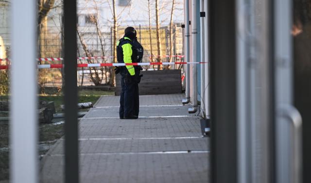 19 January 2026, Berlin: Two police officers stand in front of a daycare center in Niederschoeneweide, where a child dies in an accident. Photo: Britta Pedersen/dpa