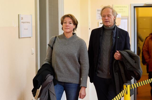 20 January 2026, Hamburg: Christina Block, German restaurateur and entrepreneur, and her partner, Gerhard Delling, former TV presenter and sports journalist, leave the district court during a break in the trial for alleged child abduction. In a cloak-and-dagger operation on New Year's Eve 2023/24, two children of the catering entrepreneur Block were taken from Denmark to Germany. The trial for the alleged abduction is taking place at Hamburg District Court, including against Block. Photo: Georg Wendt/dpa