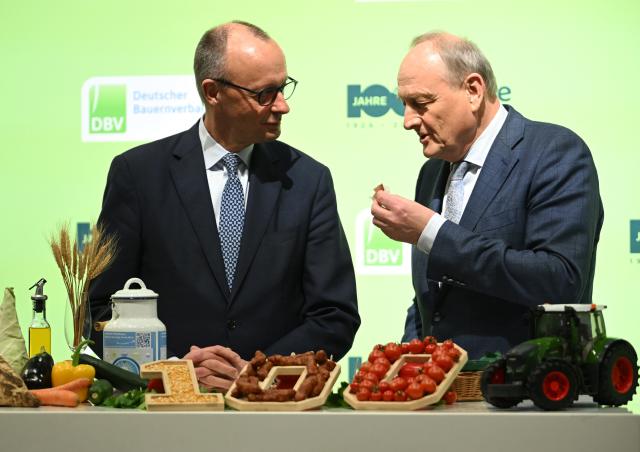 20 January 2026, Berlin: German Chancellor Friedrich Merz (L) speaks to Joachim Rukwied, President of the German Farmers' Association, during a tour of the German Farmers' Association stand at the 90th International Green Week. Photo: Britta Pedersen/dpa