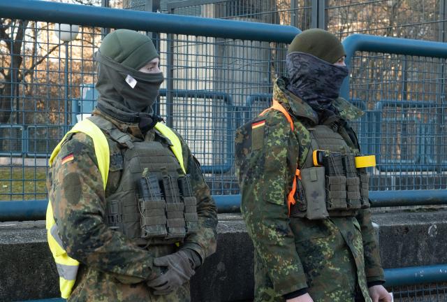20 January 2026, Berlin: Masked members of the German Armed Forces stand at the "MAEusebunker," a former research site in western Berlin, during an exercise to combat enemy agents within Germany. Photo: Wolfram Steinberg/dpa