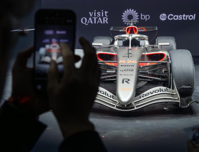 20 January 2026, Berlin: Audi Revolut's R26 Formula 1 race car is illuminated by spotlights on a rotating stage during the vehicle's presentation at the Kraftwerk Mitte power station. Photo: Soeren Stache/dpa