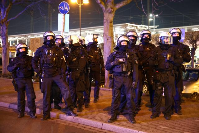 20 January 2026, North Rhine-Westphalia, Dortmund: Police officers stand at the edge of a pro-Kurdish demonstration under the slogan "Against the killing of innocent people, civilians, and children." Photo: Alex Talash/dpa