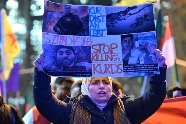 21 January 2026, Hesse, Frankfurt/Main: A demonstrator holds up a poster reading "Kurdistan lives - Stop Killing Kurds" at a pro-Kurdish demonstration called for greater solidarity with Kurds in Syria. Photo: Michael Brandt/dpa