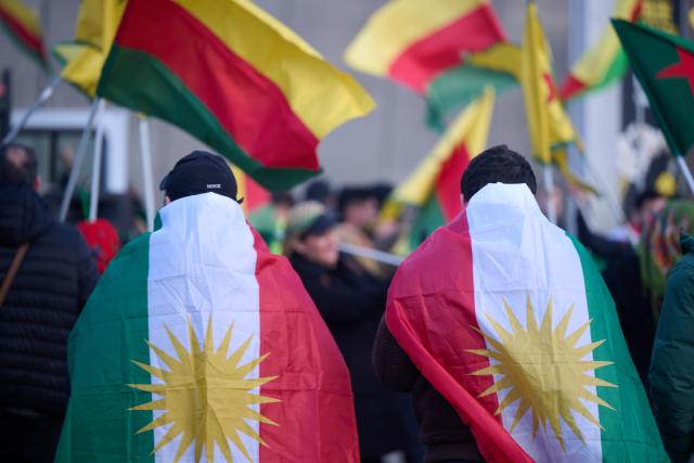 23 January 2026, North Rhine-Westphalia, Dortmund: People stand with Kurdistan flags during a pro-Kurdish demonstration at the main train station. Photo: Bernd Thissen/dpa
