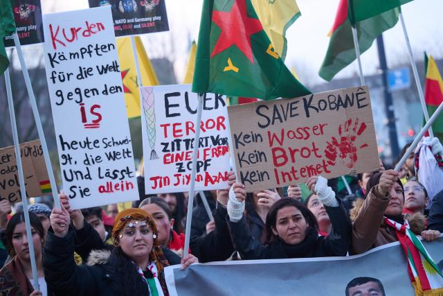 23 January 2026, North Rhine-Westphalia, Dortmund: People with flags and posters take part in a pro-Kurdish demonstration at the main train station. Photo: Bernd Thissen/dpa