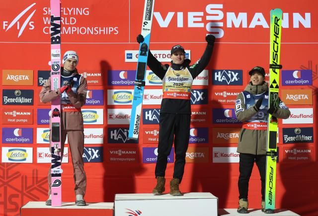 24 January 2026, Bavaria, Oberstdorf: (L-R) Norway's second placed Marius Lindvik, Slovenia's winner Domen Prevc and Japan's third placed Ren Nikaido celebrates on the podium after the men's 4th round ski flying competition at the FIS Ski Flying World Championships in Oberstdorf. Photo: Karl-Josef Hildenbrand/dpa