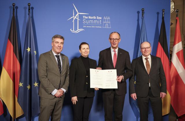 26 January 2026, Hamburg: Germany's Chancellor Friedrich Merz (2nd R), Mette Frederiksen (2nd L), Denmark's Prime Minister, Lars Aagaard (L), Denmark's Minister for Climate, Energy, and Utilities, and Frank Wetzel, State Secretary at the Germany's Ministry for Economic Affairs and Energy, stand with an agreement on "Bornholm Energy Island" at the summit meeting of the North Sea coastal states in the town hall. Photo: Christian Charisius/dpa-Pool/dpa