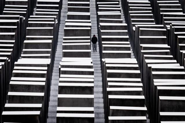 27 January 2026, Berlin: A person walks through the field of stelae at the Memorial to the Murdered Jews of Europe on International Holocaust Memorial Day in Memory of the Victims. Photo: Christoph Soeder/dpa