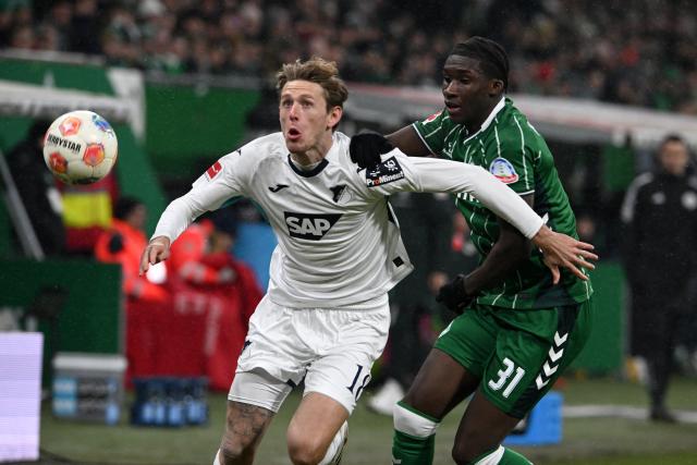 27 January 2026, Bremen: Hoffenheim's Wouter Burger (L) and Bremen's Karim Coulibaly battle for the ball during the German Bundesliga soccer match between Werder Bremen and TSG 1899 Hoffenheim at the Weserstadion. Photo: Carmen Jaspersen/dpa