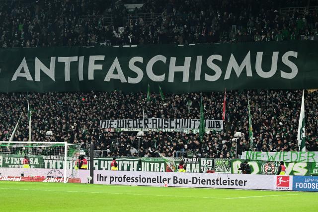 27 January 2026, Bremen: Bremen fans hold banners reading "Anti-fascism" and #never again Auschwitz" before the German Bundesliga soccer match between Werder Bremen and TSG 1899 Hoffenheim at the Weserstadion. Photo: Carmen Jaspersen/dpa