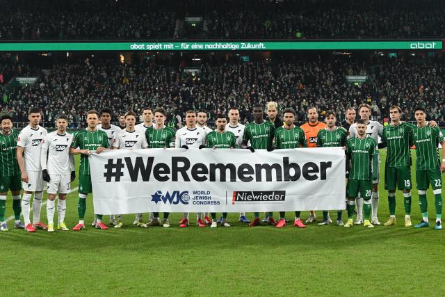 27 January 2026, Bremen: Bremen players hold a banner with the inscription "'WeRemember" before the German Bundesliga soccer match between Werder Bremen and TSG 1899 Hoffenheim at the Weserstadion. Photo: Carmen Jaspersen/dpa