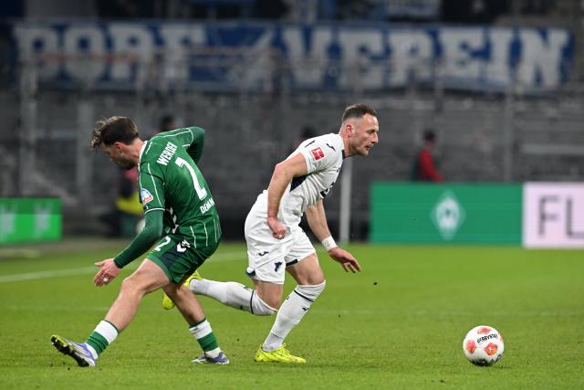 27 January 2026, Bremen: Bremen's Olivier Deman and Hoffenheim's Vladimir Coufal battle for the ball during the German Bundesliga soccer match between Werder Bremen and TSG 1899 Hoffenheim at the Weserstadion. Photo: Carmen Jaspersen/dpa