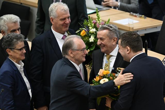 28 January 2026, Saxony-Anhalt, Magdeburg: Sven Schulze, receives flowers and congratulations in the plenary chamber of the Saxony-Anhalt state parliament. Reiner Haseloff, former Minister President of Saxony-Anhalt, congratulates Schulze after he was elected as the state's new Minister President. Photo: Hendrik Schmidt/dpa