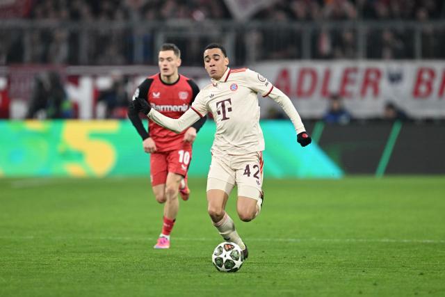 FILED - 05 March 2025, Bavaria, Munich: Bayern Munich's Jamal Musiala and Leverkusen's Florian Wirtz (L) battle for the ball during the UEFA Champions League round of 16 first-leg soccer match between Bayern Munich and Bayer Leverkusen at Allianz Arena. oung German stars like Jamal Musiala, Florian Wirtz and Nick Woltemade are not quite ready yet to win the World Cup in summer, former national team great Thomas Mueller believes. Photo: Sven Hoppe/dpa