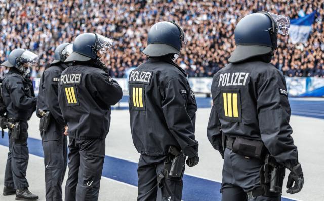 FILED - 01 November 2025, Berlin: Police officers in protective gear stand in front of the stands during the German 2nd Bundesliga soccer match between Hertha BSC and Dynamo Dresden at the Olympic Stadium. Photo: Andreas Gora/dpa