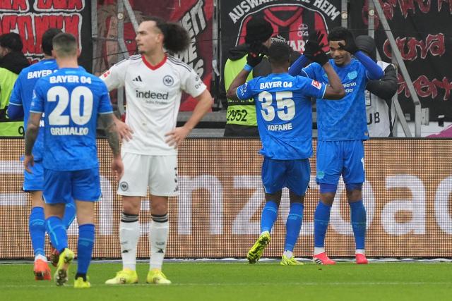 31 January 2026, Hesse, Frankfurt/M.: Leverkusen's Malik Tillmann celebrates scoring his side's second goal with teammate Christian Kofane during the German Bundesliga soccer match between Eintracht Frankfurt and Bayer Leverkusen at the Deutsche Bank Park. Photo: Marc Schüler/dpa - IMPORTANT NOTICE: DFL and DFB regulations prohibit any use of photographs as image sequences and/or quasi-video.