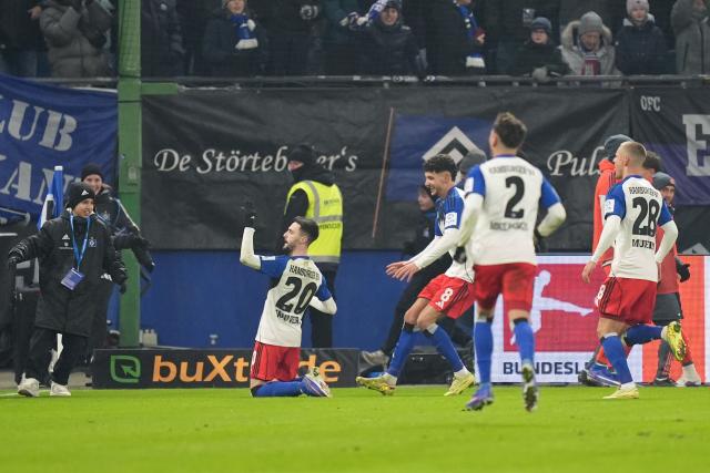 31 January 2026, Hamburg: Hamburger's Fabio Vieira celebrates scoring his side's first goal with teammates during th
e German Bundesliga soccer match between Hamburger SV and FC Bayern Munich at the Volksparkstadion Photo: Marcus Brandt/dpa - IMPORTANT NOTICE: DFL and DFB regulations prohibit any use of photographs as image sequences and/or quasi-video.
