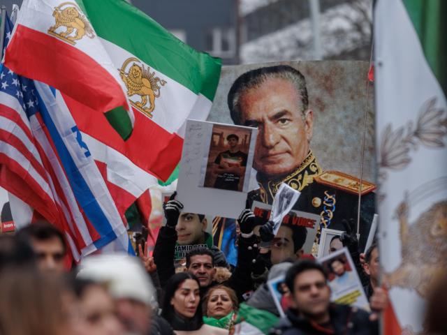 31 January 2026, Hamburg: Protesters hold pictures of Reza Pahlavi, the son of the former Shah Mohammad Reza Pahlavi and wave Iran's Pre-Islamic revolution flags during the  demonstration "No to the Islamic Republic of Iran!" against violence by the Iranian government. Photo: Markus Scholz/dpa