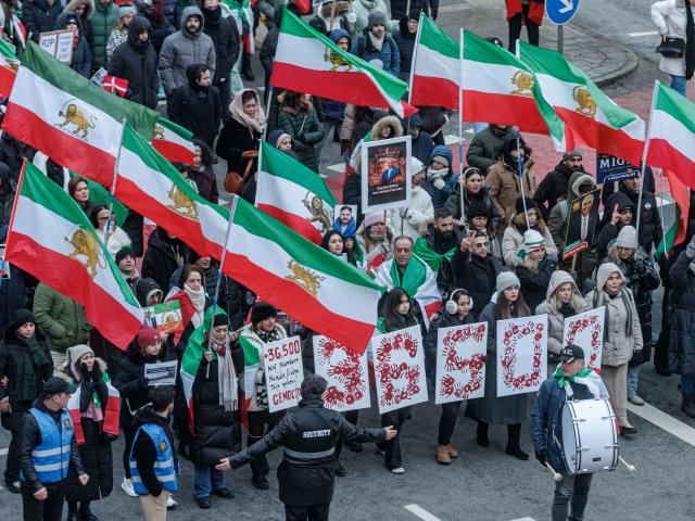 31 January 2026, Hamburg: Protesters hold pictures of Reza Pahlavi, the son of the former Shah Mohammad Reza Pahlavi and wave Iran's Pre-Islamic revolution flags during the  demonstration "No to the Islamic Republic of Iran!" against violence by the Iranian government. Photo: Markus Scholz/dpa