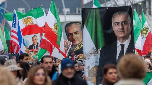 31 January 2026, Hamburg: Protesters hold pictures of Reza Pahlavi, the son of the former Shah Mohammad Reza Pahlavi and wave Iran's Pre-Islamic revolution flags during the  demonstration "No to the Islamic Republic of Iran!" against violence by the Iranian government. Photo: Markus Scholz/dpa