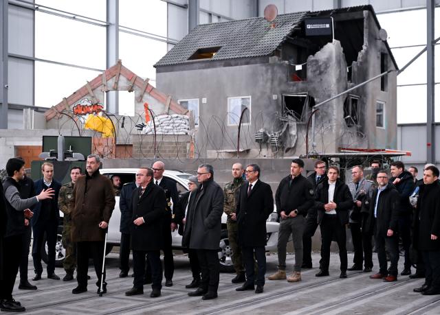 02 February 2026, Bavaria, Erding: Boris Pistorius, German Minister of Defense, and Markus Soeder, Minister-President of Bavaria, stand in a hall in which a possible operational area has been recreated for practice during the opening of the Bundeswehr Innovation Center. The innovation center is to become the interface between start-ups, the civilian research and industrial landscape and the Bundeswehr. Photo: Sven Hoppe/dpa