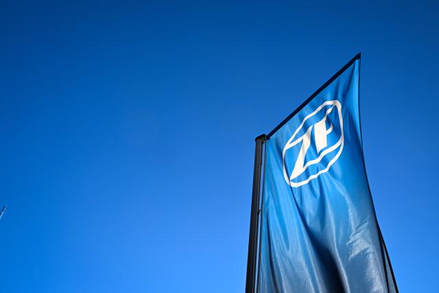 FILED - 19 March 2025, Baden-Wuerttemberg, Friedrichshafen: A flag bearing the ZF Friedrichshafen logo flies in front of the ZF Friedrichshafen forum. Photo: Felix Kästle/dpa