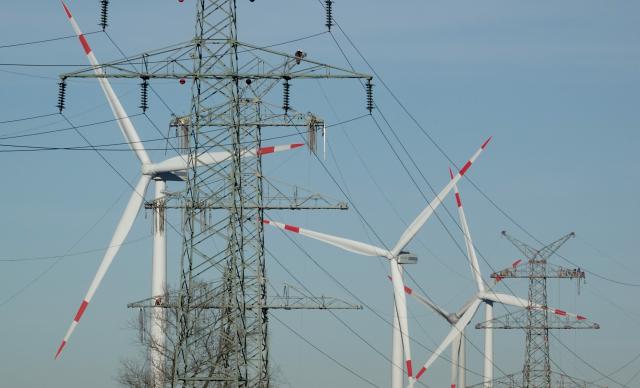 FILED - 15 February 2019, Schleswig-Holstein, St.Michaelisdonn: Power poles belonging to the West Coast power line are visible from wind turbines. The German government is taking a stake in power grid operator TenneT Germany as part of efforts to expand the country's electricity network. Photo: Carsten Rehder/dpa