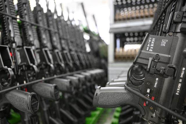 FILED - 28 February 2022, Baden-Wuerttemberg, Oberndorf: Finished HK416 assault rifles are lined up in the production hall of arms manufacturer Heckler & Koch in Oberndorf. The volume of arms exports approved by the German government fell slightly last year to around ·12 billion ($14.2 billion), preliminary figures published on Friday by the Economy Ministry in Berlin showed. Photo: Bernd Weißbrod/dpa