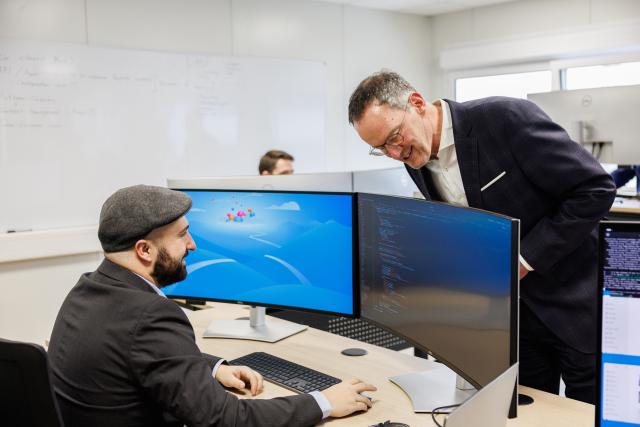 06 February 2026, Rhineland-Palatinate, Mainz: Minister of the Interior of Rhineland-Palatinate Michael Ebling (R) looks over the monitor of a police officer ahead of a press conference to demonstrate how the detector will be used to recognize and analyze manipulated image content in the future. Photo: Hannes P. Albert/dpa