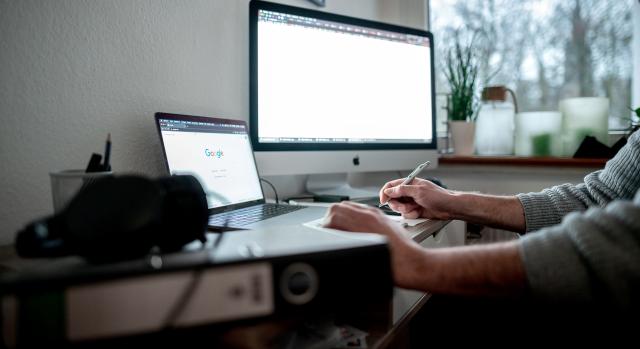 FILED - 19 January 2021, North Rhine-Westphalia, Oberhausen: A man sits with a laptop and a screen at his home office. Photo: Fabian Strauch/dpa