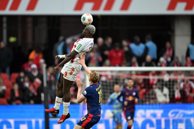 08 February 2026, North Rhine-Westphalia, Cologne: Cologne's Ragnar Ache and Leipzig's Nicolas Seiwald battle for a header during the German Bundesliga soccer match between 1.FC Cologne and RB Leipzig at RheinEnergieStadion. Photo: Federico Gambarini/dpa - IMPORTANT NOTE: In accordance with the regulations of the DFL German Football League and the DFB German Football Association, it is prohibited to utilize or have utilized photographs taken in the stadium and/or of the match in the form of sequential images and/or video-like photo series.