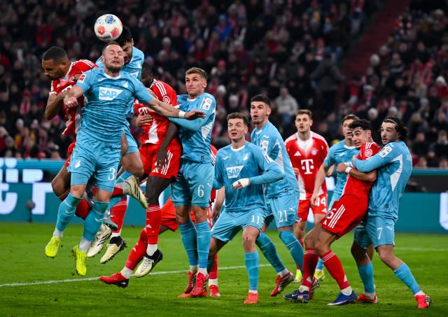 08 February 2026, Bavaria, Munich: Bayern Munich's and Hoffenheim's players battle for the ball during the German Bundesliga soccer match between Bayern Munich and TSG 1899 Hoffenheim at the Allianz Arena. Photo: Sven Hoppe/dpa - IMPORTANT NOTE: In accordance with the regulations of the DFL German Football League and the DFB German Football Association, it is prohibited to utilize or have utilized photographs taken in the stadium and/or of the match in the form of sequential images and/or video-like photo series.
