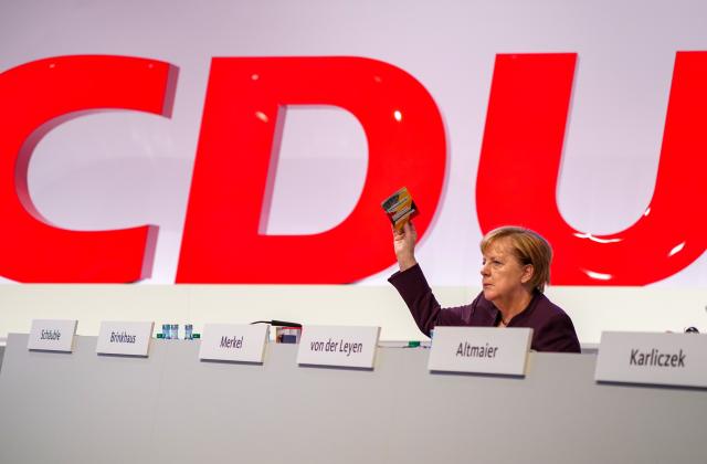 FILED - 22 November 2019, Saxony, Leipzig: Then German Chancellor Angela Merkel holds up her voting card at the CDU federal party conference in Leipzig. Photo: Kay Nietfeld/dpa