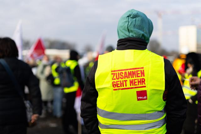 10 February 2026, Lower Saxony, Hanover: Demonstrators stand at a rally on Schützenplatz in Hanover. The police union, the education and science union and IG BAU call on their members to go on warning strike. Photo: Michael Matthey/dpa