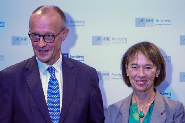 FILED - 21 November 2025, North Rhine-Westphalia, Arnsberg: German Chancellor Friedrich Merz and his wife Charlotte Merz pose during the annual reception of the Arnsberg-Hellweg-Sauerland Chamber of Industry and Commerce. Photo: Christoph Reichwein/dpa