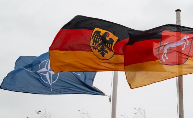 FILED - 11 October 2019, Lower Saxony, Bergen: Flags of NATO, the Germany and the State of Lower Saxony fly on the fringes of the information training exercise Land Operations 2019. Photo: Philipp Schulze/dpa