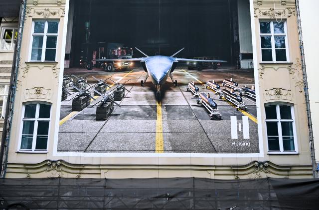 11 February 2026, Bavaria, Munich: A poster for the arms manufacturer Helsing hangs on a wall near the Hotel Bayerischer Hof. The 62nd Munich Security Conference (MSC) takes place from February 13 to 15, 2026, at the Hotel Bayerischer Hof in Munich. Photo: Sven Hoppe/dpa - ACHTUNG: Nur zur redaktionellen Verwendung im Zusammenhang mit der aktuellen Berichterstattung und nur mit vollständiger Nennung des vorstehenden Credits