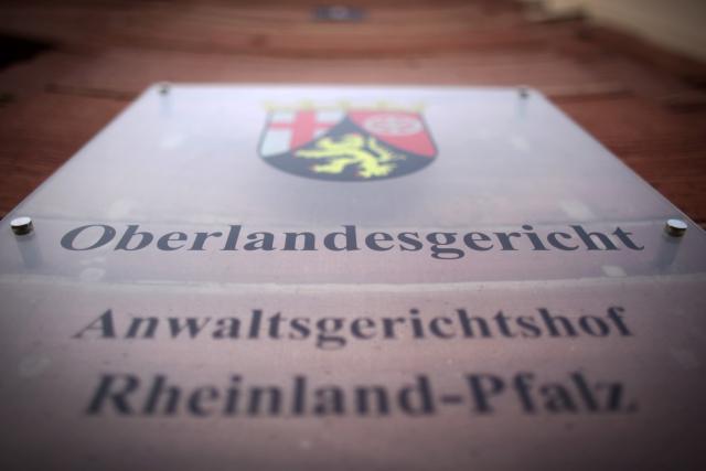 FILED - 19 October 2012, Rhineland-Palatinate, Koblenz: A view of the door sign of the Higher Regional Court in Koblenz. A US citizen was found guilty by a German court on Wednesday of planning to pass on sensitive US military information to China. Photo: Fredrik von Erichsen/dpa