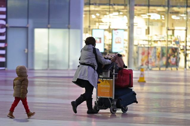 12 February 2026, Bavaria, Munich: A woman and a child walk through the central area of Munich Airport. On Thursday, Lufthansa pilots and flight attendants are going on a full-day strike at the same time. Photo: Malin Wunderlich/dpa
