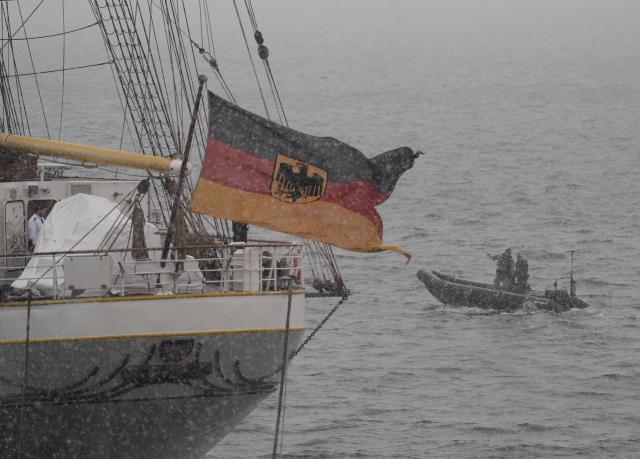 12 February 2026, Schleswig-Holstein, Kiel: A rubber dinghy passes the German training ship "Gorch Fock" in the harbor basin of the Kiel naval base during the NATO maneuver Steadfast Dart 26. With around 10,000 soldiers, Steadfast Dart 2026 is the largest NATO exercise this year. It will take place from February 1 to 20. Photo: Marcus Brandt/dpa