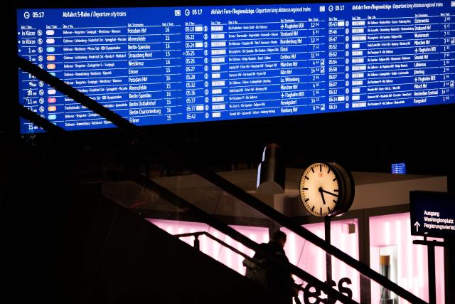 13 February 2026, Berlin: A woman rides an escalator at the main train station. Deutsche Bahn has called a security summit following the fatal attack on a train conductor in Rhineland-Palatinate. The aim of the summit is to strengthen and supplement security measures for staff and passenger Photo: Carsten Koall/dpa