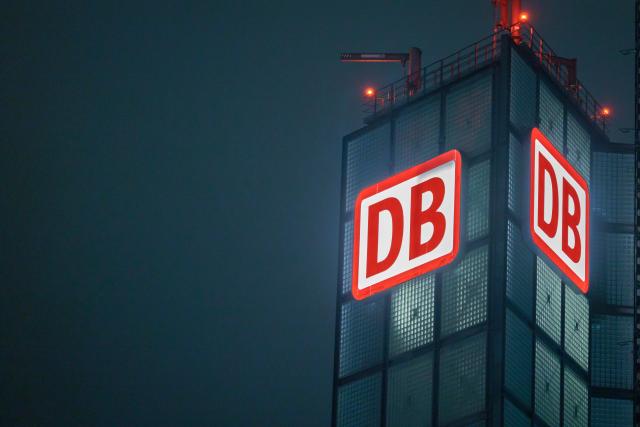 13 February 2026, Berlin: The Deutsche Bahn (DB) logo lights up a tower at Berlin Central Station. Deutsche Bahn has convened a security summit following the fatal attack on a train conductor in Rhineland-Palatinate, aiming to strengthen and supplement security measures for staff and passengers. Photo: Carsten Koall/dpa