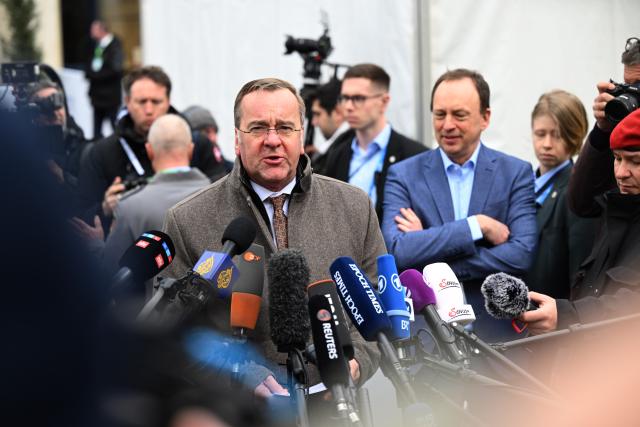 13 February 2026, Bavaria, Munich: Boris Pistorius (C), German Minister of Defence, gives an interview in front of the Bayerischer Hof during the 62nd Munich Security Conference, which will host over 60 heads of state and government-the highest number ever at the world's leading security policy meeting. Photo: Felix Hörhager/dpa
