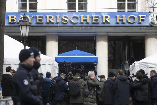 13 February 2026, Bavaria, Munich: Police officers stand at an entrance of the Bavarian Court, the venue for the 62nd Munich Security Conference, which will host over 60 heads of state and government-the highest number ever at the world's leading security policy meeting. Photo: Marijan Murat/dpa