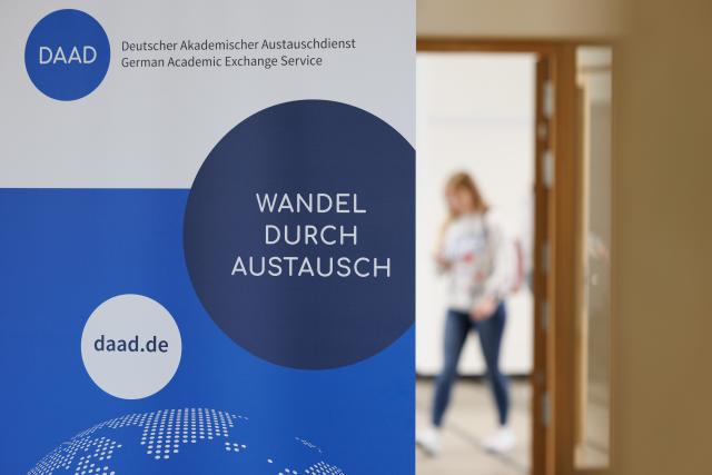 FILED - 07 June 2024, North Rhine-Westphalia, Muenster: A roll-up banner with the logo od the Germany Academic Exchange Servive (DAAD) is pictured at a meeting for international students in Muenster. Photo: Friso Gentsch/dpa